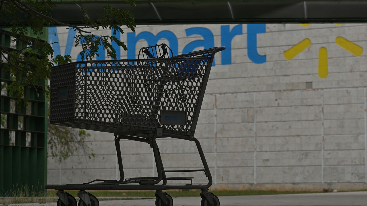 Empty shopping cart at a Walmart entrance.