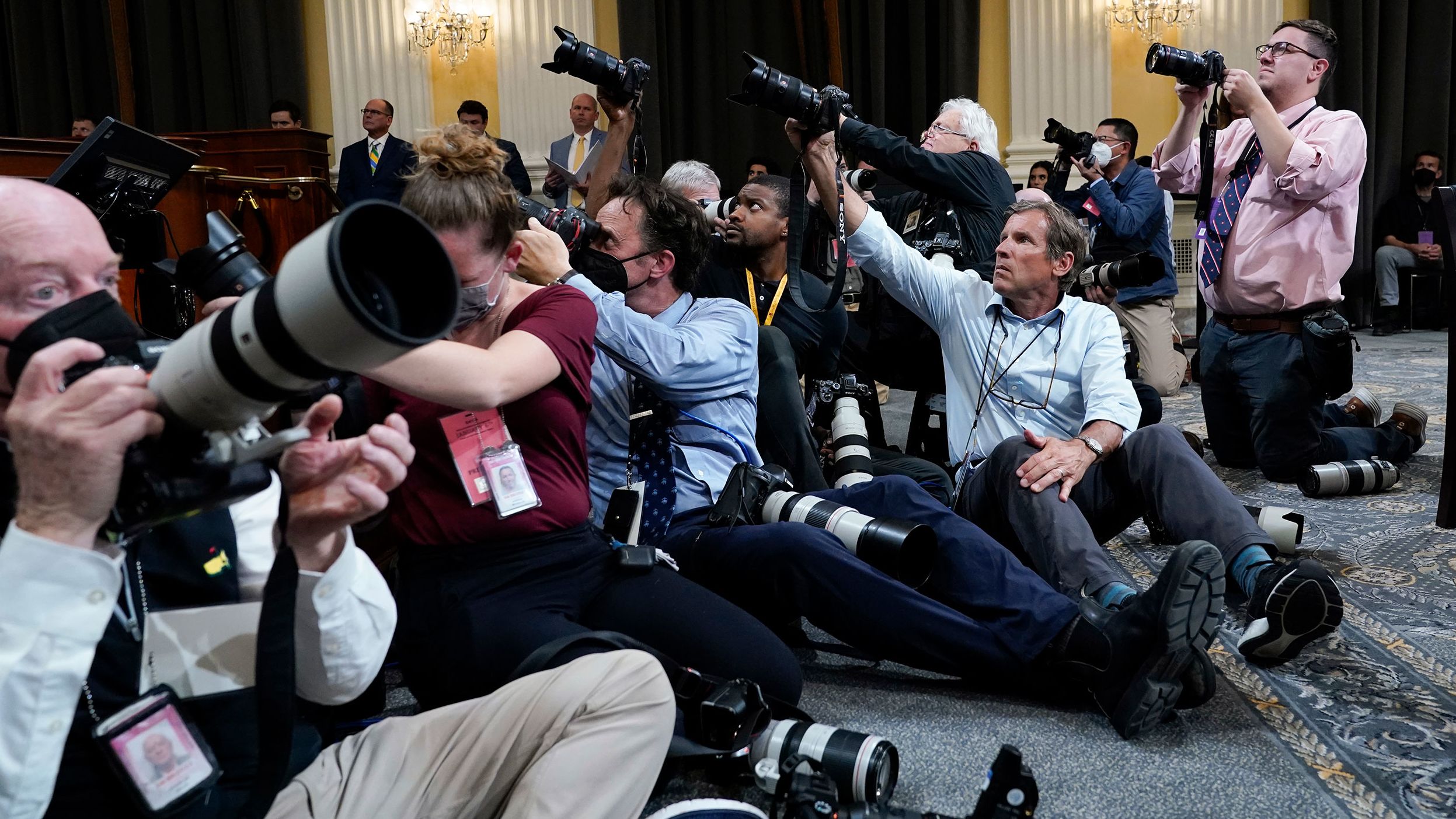 Photographers document the hearing on June 28.