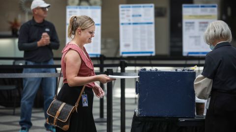Harper Brown of Denver turns in her ballot as she votes on June 28, 2022.