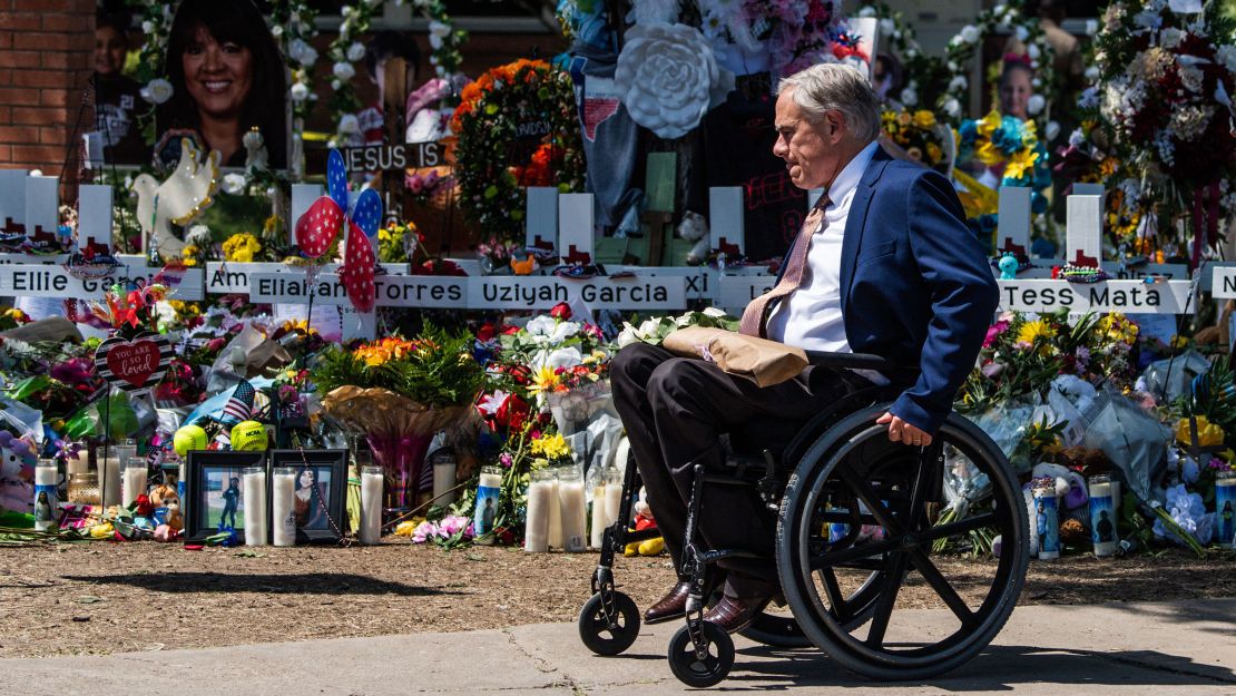 Texas Gov. Greg Abbott visits a makeshift memorial outside Robb Elementary School on May 29.