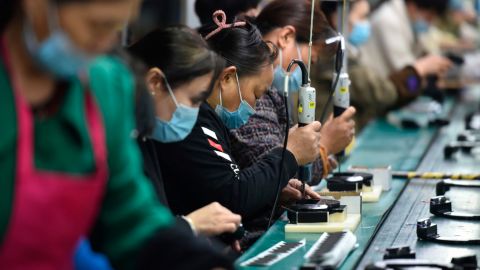 Workers assemble speakers at an electronics factory in Linquan, Anhui province.