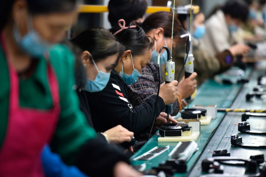 Workers assemble speakers at an electronics factory in Linquan, Anhui province. 
