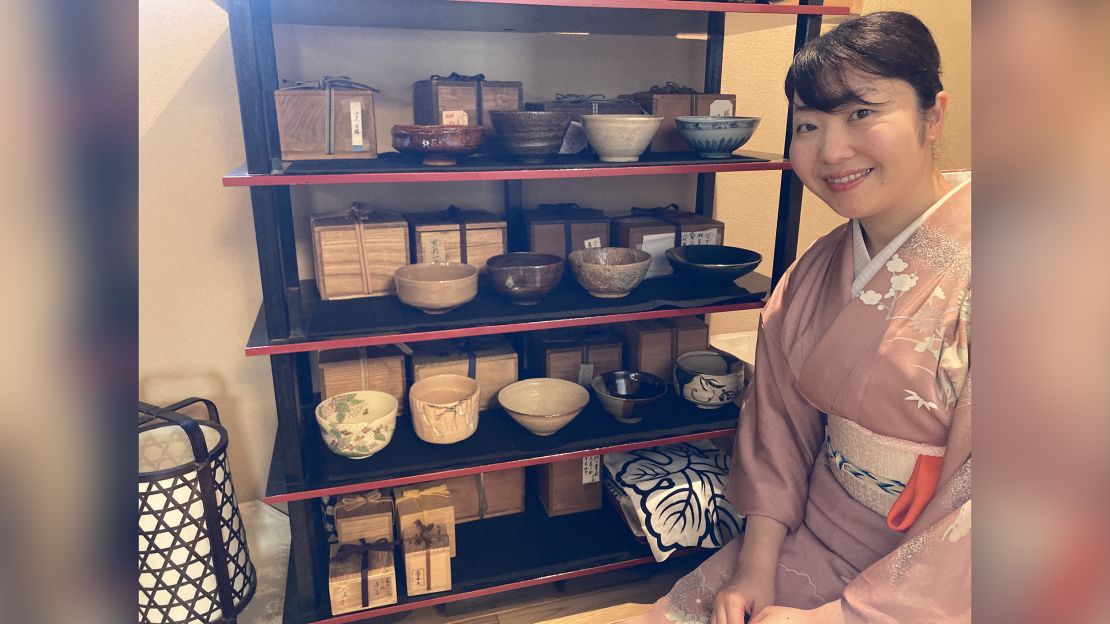 Atsuko Okubo shows some her family's antique tea bowls available for customers to choose for use during a Japanese tea ceremony.