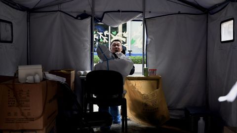 A health worker takes a sample from a man testing for Covid-19 at a swab collection site in Beijing, in June.