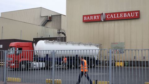 Employees walk at Barry Callebaut production site in Wieze, near Brussels, on June 30, 2022. Swiss group Barry Callebaut, the world's largest cocoa and chocolate company, said on June 30, 2022, that it had halted chocolate production at its Wieze (Belgium) factory, billed as the world's largest, after salmonella was found in a batch on June 26.