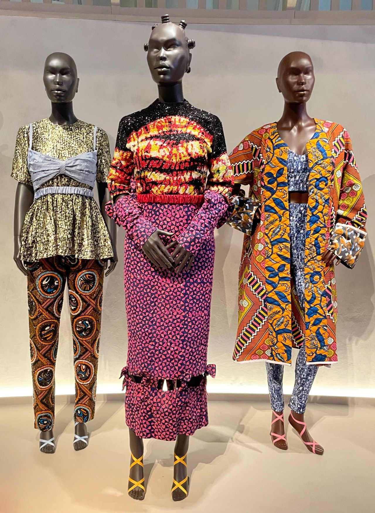 These pieces by Lisa Folawiyo, on display at the exhibition, feature a mix of contrasting patterns and colors.