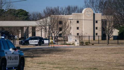 Law enforcement vehicles sit in front of the Congregation Beth Israel synagogue on January 16, 2022 in Colleyville, Texas.