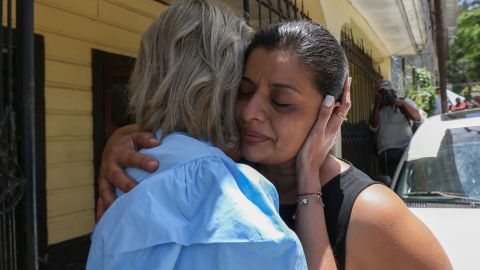 Karen Caballero is comforted during an impromptu conference at her home in Las Vegas, Honduras. Her two sons were among the victims of what is described as the deadliest human smuggling incident in US history.