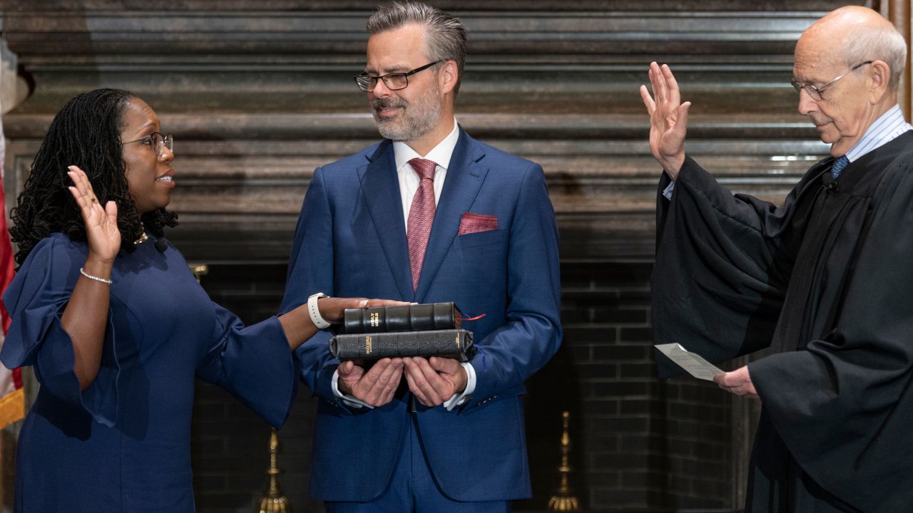 Justice Stephen Breyer administers the Judicial Oath to Jackson as her husband, Patrick, holds the Bible in June 2022.