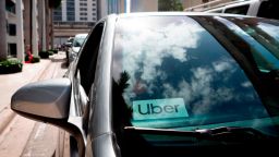 An Uber sticker is seen on a car windshield on the street in downtown Miami on January 9, 2020.  