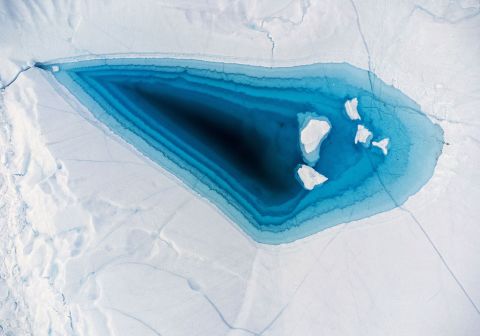 Water is seen on top of an iceberg in Greeland's Disko Bay on Wednesday, June 29.
