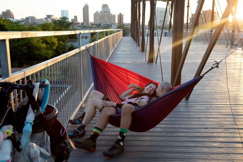 Jennifer Martin and Greg Lerma relax on a hammock on the Hays Street Bridge in San Antonio on Friday, June 24. 