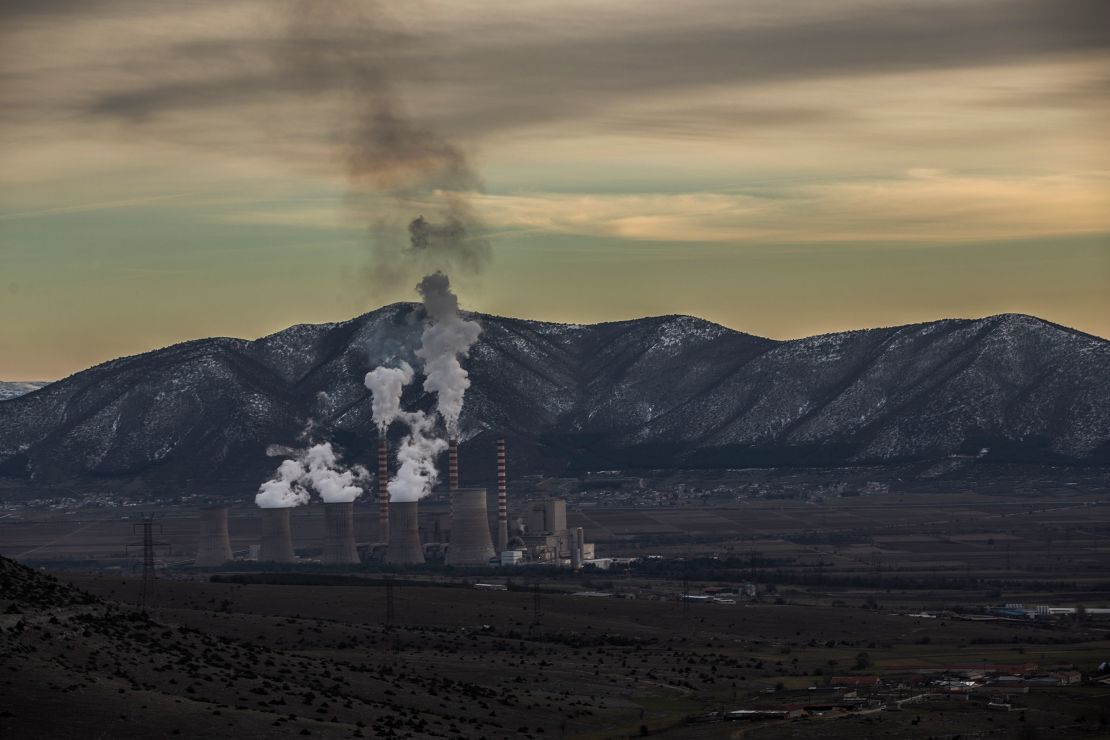 A general view of the hill where Charalambos Mouratidis' farm is located in Akrini, with a coal plant in the background.