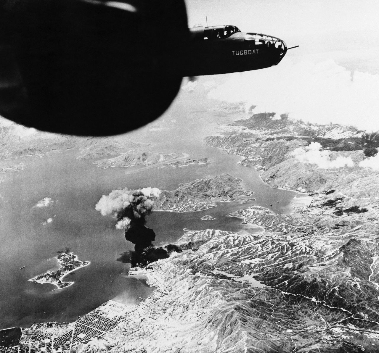United States Air Force bombers set fire to a Japanese oil depot in the Lai Chi Kok neighborhood on October 19, 1943, sending smoke 15,000 feet high. Stonecutter's Island, pictured at left, once held a British ammunition dump.