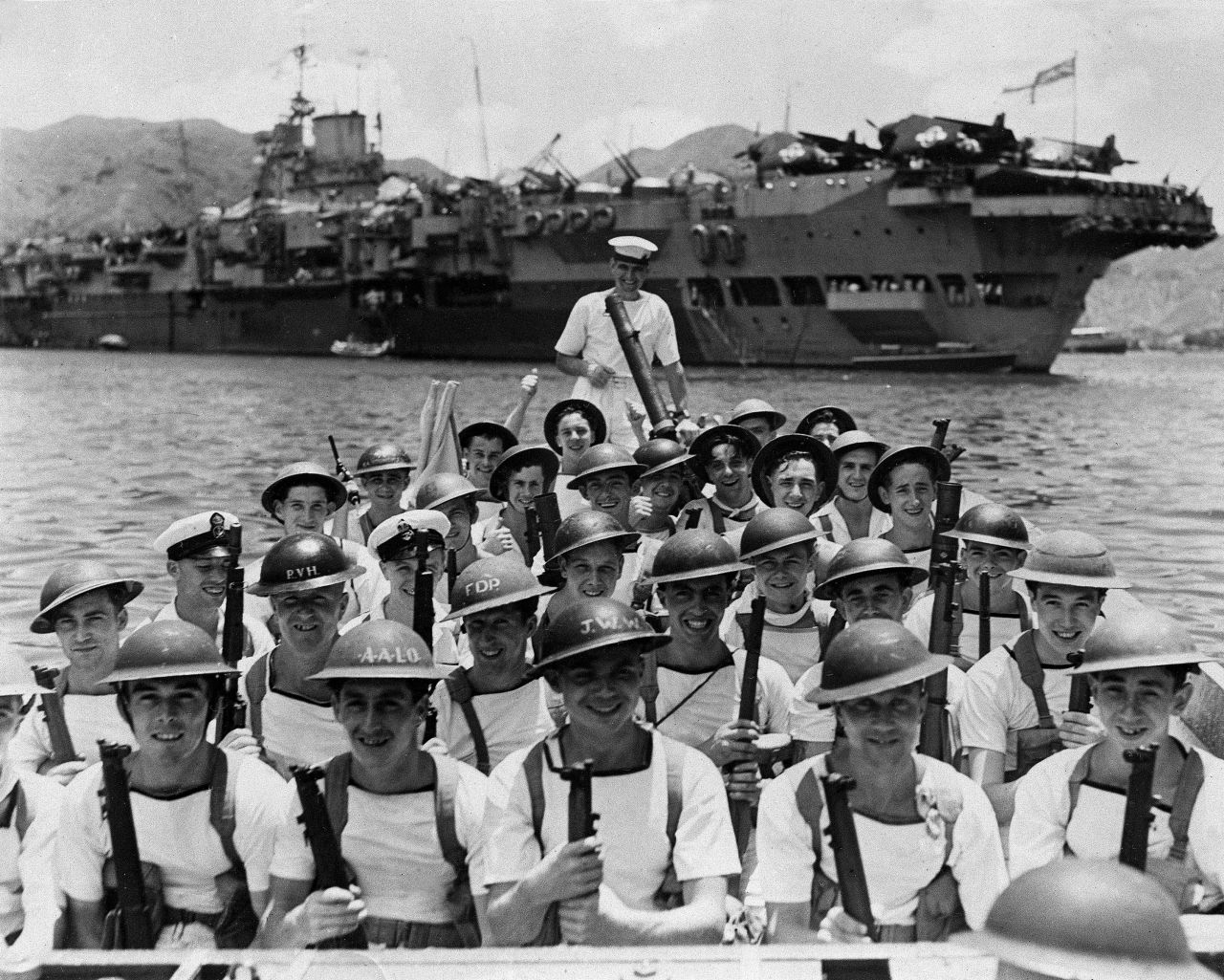 A British landing party leaves the HMS Indomitable aircraft carrier, heading to guard key points on shore as British forces move in to accept Japan's surrender in Hong Kong at the end of World War II in 1945.