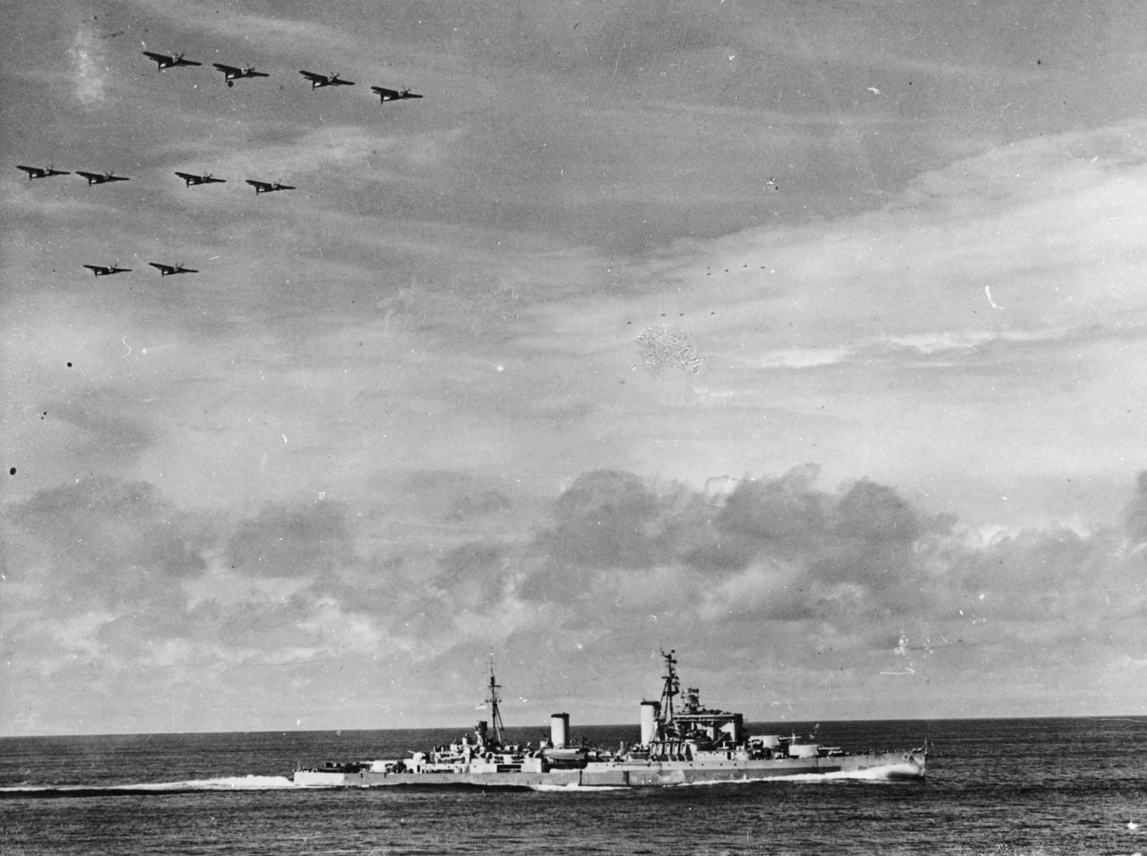 Barracuda aircraft fly in formation above the HMS Swiftsure as the British Royal Navy battleship heads to Hong Kong to accept surrender from the Japanese in 1945.