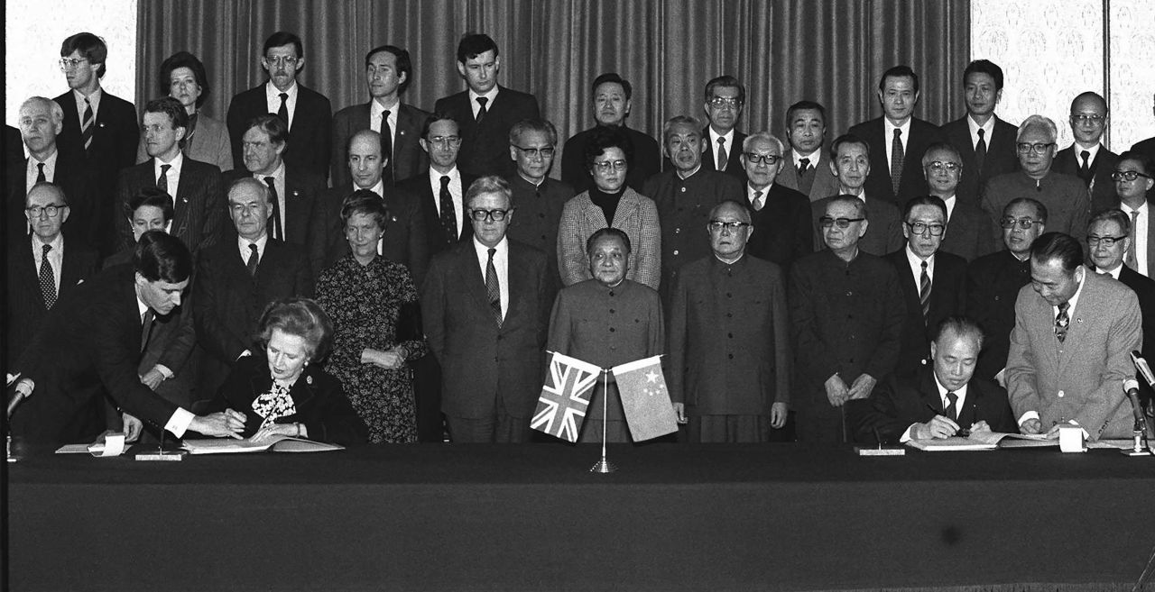 Thatcher and Chinese Premier Zhao Ziyang sign copies of the Hong Kong handover agreement in Beijing on December 19, 1984. At front center is China's then-top leader, Deng Xiaoping.