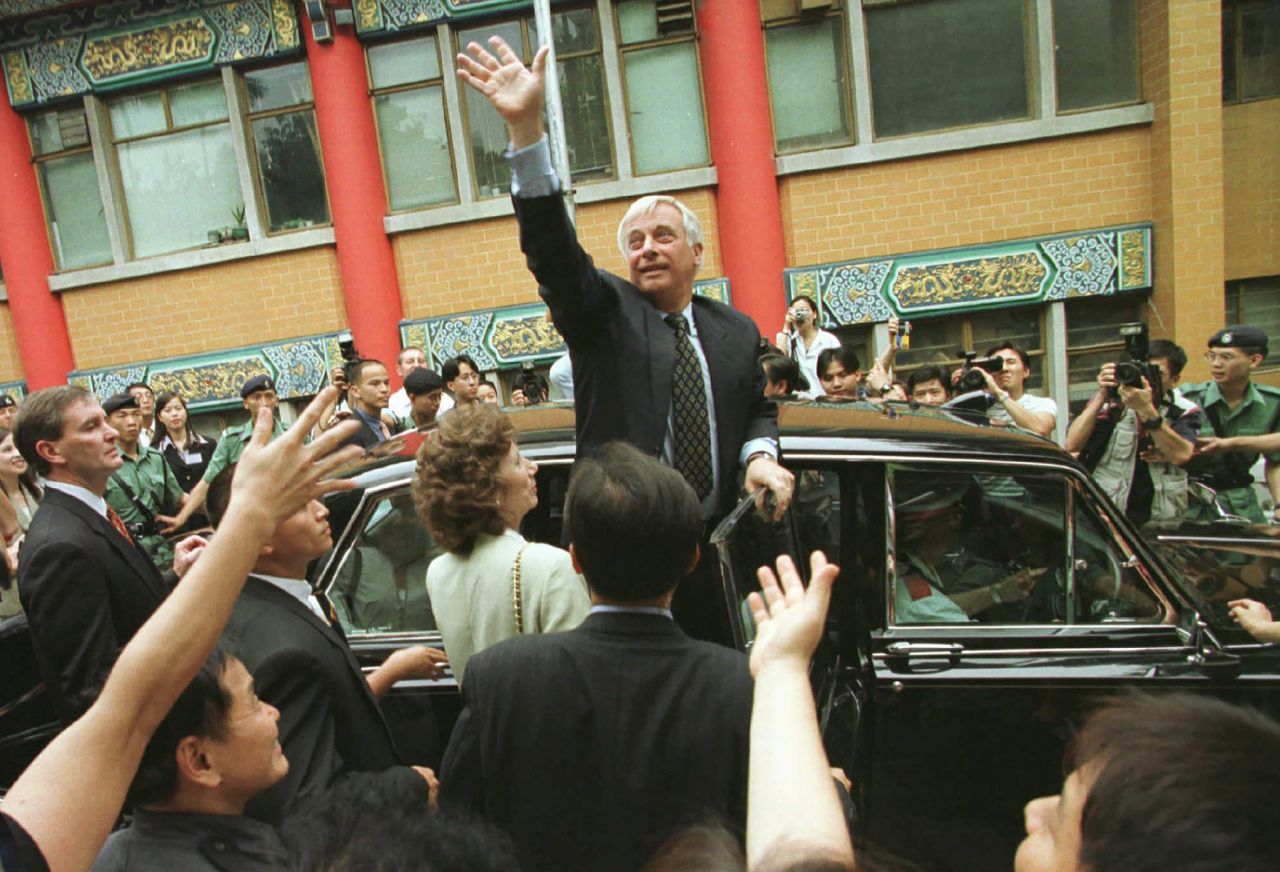 Patten greets the crowds gathered at the Wong Tai Sin temple during a visit on June 27, 1997. Patten attended a ceremony at the temple seeking blessings for the people of Hong Kong, days ahead of its handover to China.