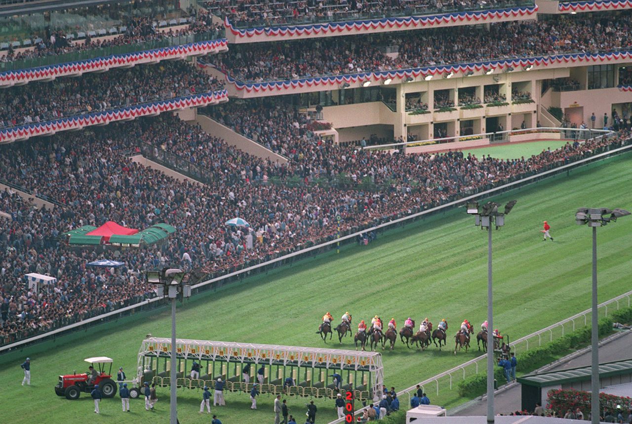 After being closed for renovations, the Happy Valley Racecourse reopened with a race in front of a packed stand on November 25, 1995. Patten was among the 45,815 fans whose wagers made up a total of $1.1 billion on the twilight meeting.