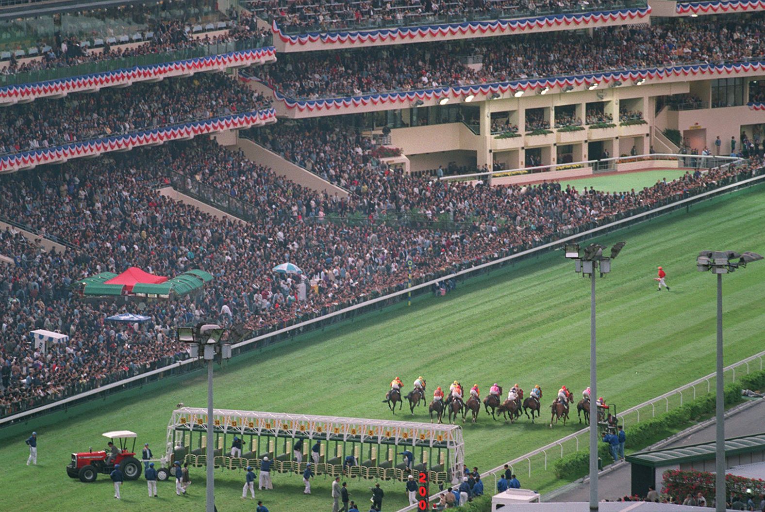 After being closed for renovations, the Happy Valley Racecourse reopened with a race in front of a packed stand on November 25, 1995. Patten was among the 45,815 fans whose wagers made up a total of $1.1 billion on the twilight meeting.