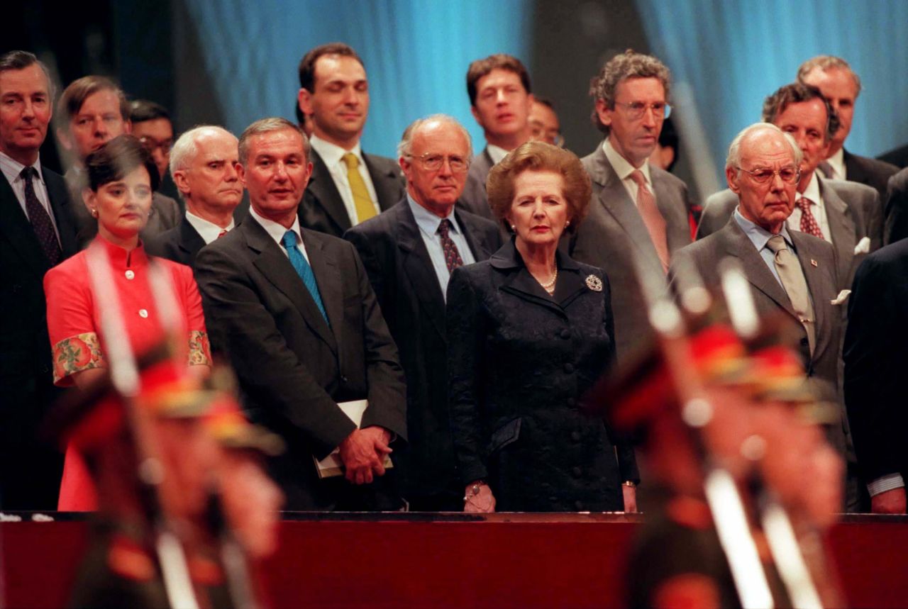 Members of the British delegation, including former Prime Minister Margaret Thatcher, watch soldiers march past during the 1997 handover ceremony.