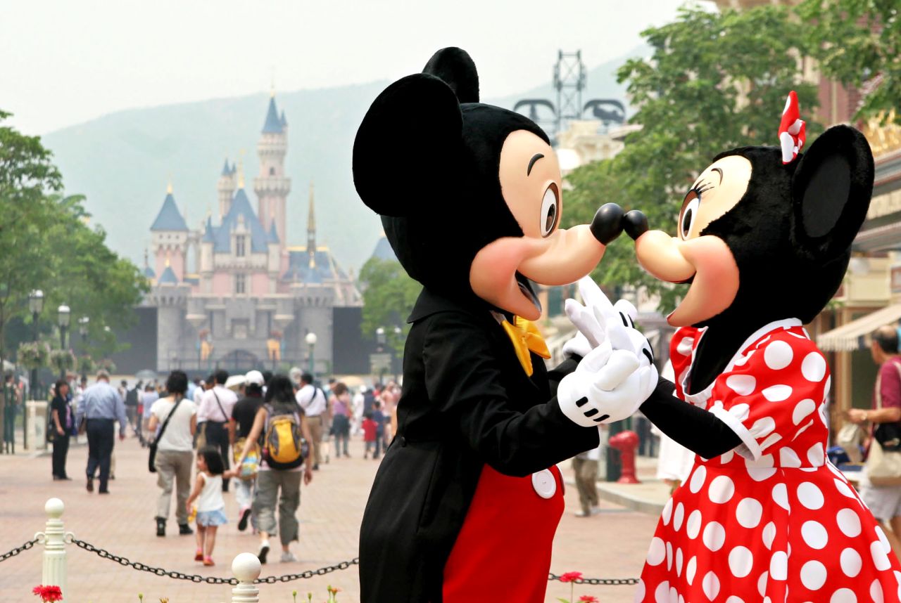 Performers in Mickey Mouse and Minnie Mouse costumes play on the main street of Hong Kong Disneyland, one day before its official opening in 2005.
