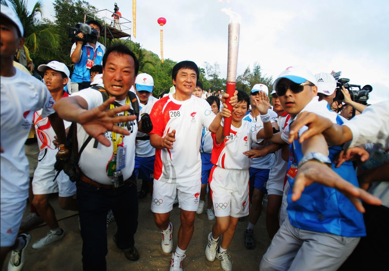 Movie star and Hong Kong native Jackie Chan carries the Olympic Torch during the Olympic Torch Relay in Sanya, China, in 2008.