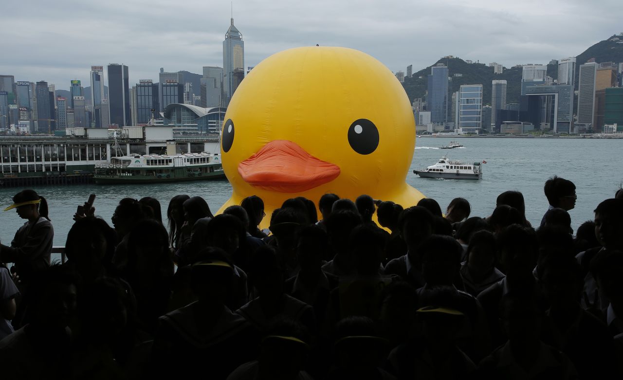 A 16.5-meter (54-foot) rubber duck, created by the Dutch artist Florentijn Hofman, is towed along Hong Kong's Victoria Harbor in 2013.