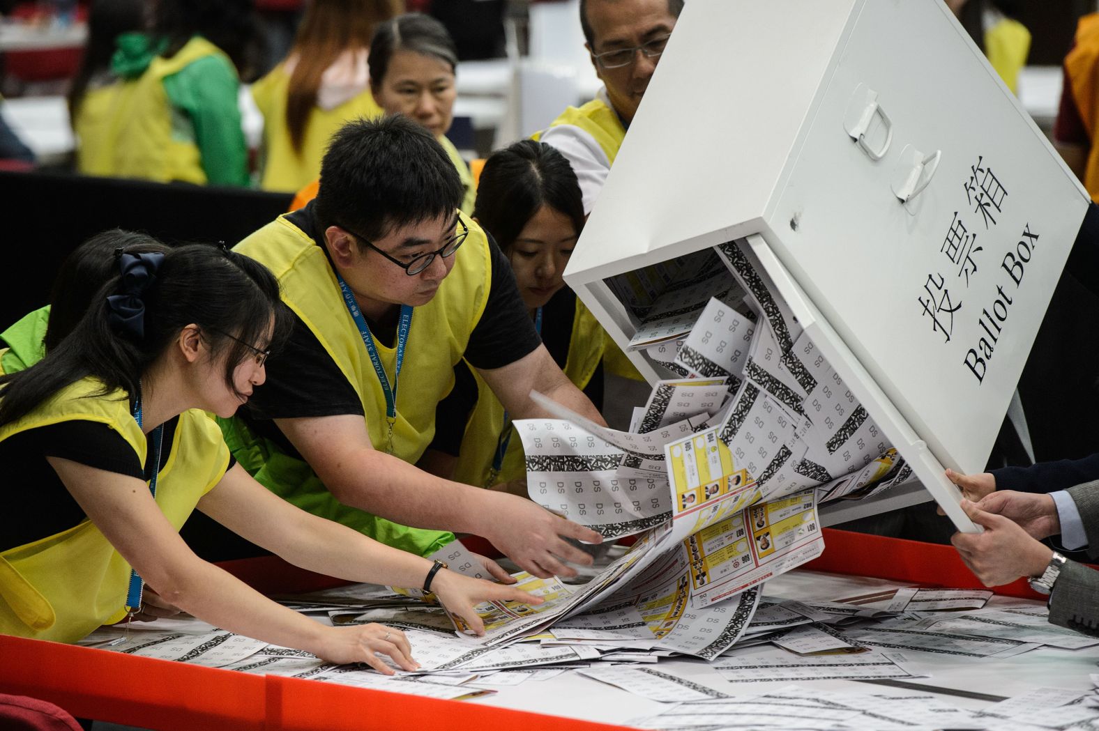 Election officials empty a ballot box for counting after voting stations closed for the Legislative Council election in Hong Kong in 2016.