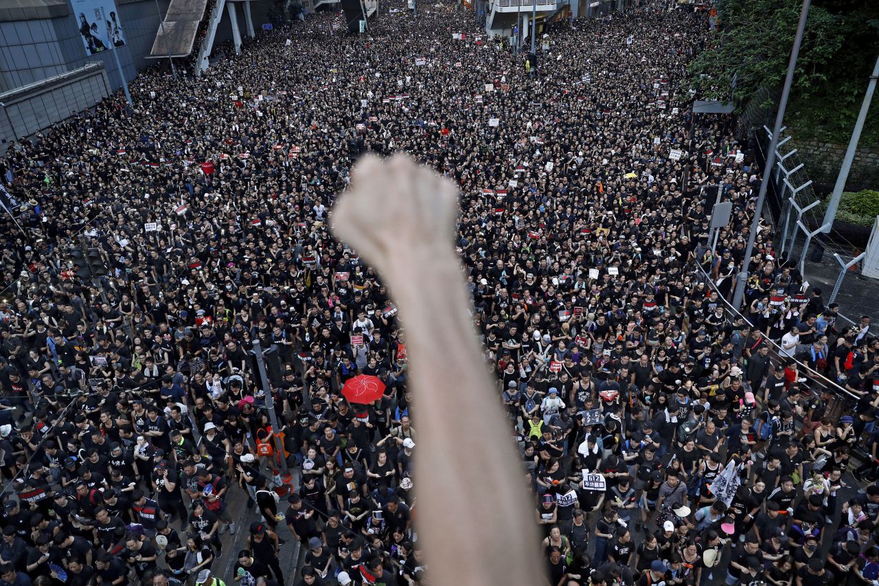 A protester raises a fist as demonstrators march against a proposed extradition bill in Hong Kong in 2019.