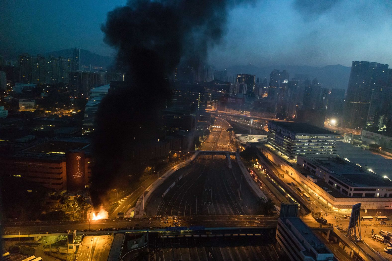 Smoke billows from a fire next to Hong Kong Polytechnic University and the road leading to the Cross Harbour Tunnel amid anti-government protests in 2019.
