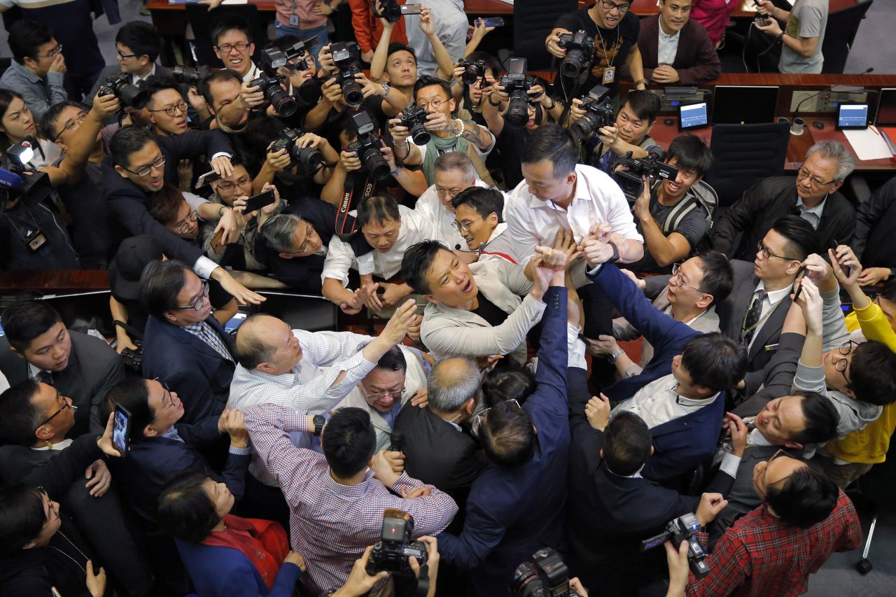 Pro-democracy and pro-Beijing lawmakers scuffle in the chamber of the Legislative Council in Hong Kong in 2019.
