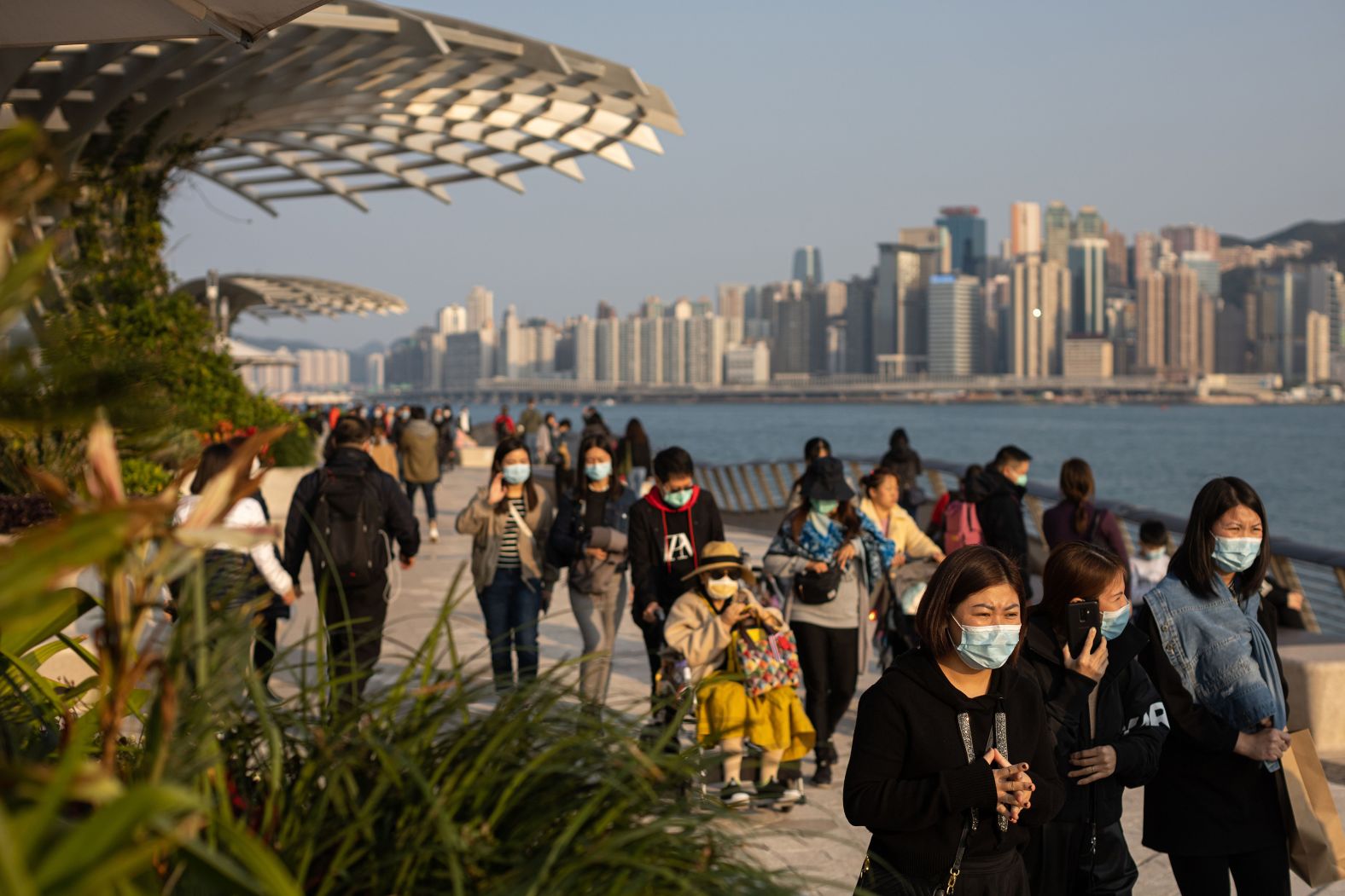 People wear face masks on the Tsim Sha Tsui waterfront promenade in Hong Kong in January 2020, as the novel coronavirus was spreading worldwide.