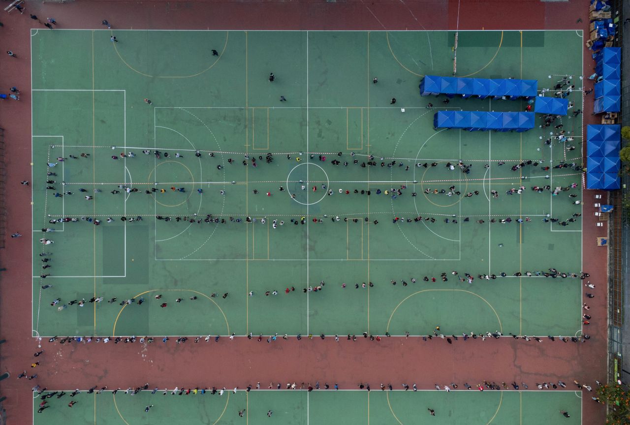 This aerial photo shows residents standing in long lines at an outdoor Covid-19 test center in Hong Kong in February 2022. The city was facing a severe wave that saw one of the highest per-capita death rates in the world.
