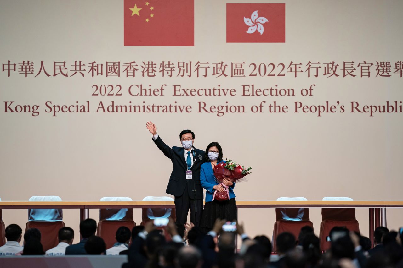 Hong Kong Chief Executive-elect John Lee celebrates on stage with his wife after being nominated for the role in May 2022. Lee, a former police officer and security chief, was the sole candidate for the city's top job.
