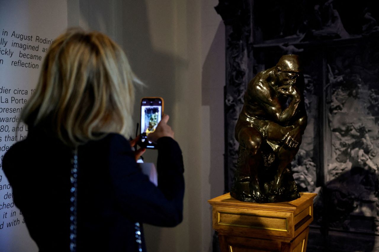 A woman takes a picture of the artwork ahead of Thursday's auction in Paris.