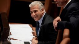 Israeli Foreign Minister Yair Lapid smiles ahead of the vote to dissolve the Knesset, Israel's parliament, in Jerusalem on June 30.