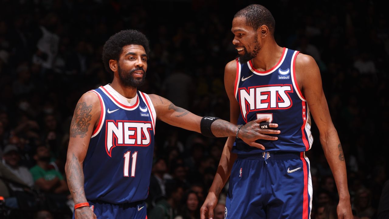 Kyrie Irving talks to Durant during Game 4 of the Eastern Conference first round in the 2022 NBA Playoffs.