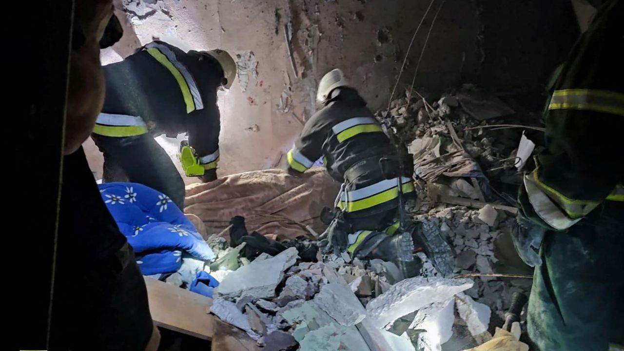 Rescue workers are pictured at the scene of the missile strike.