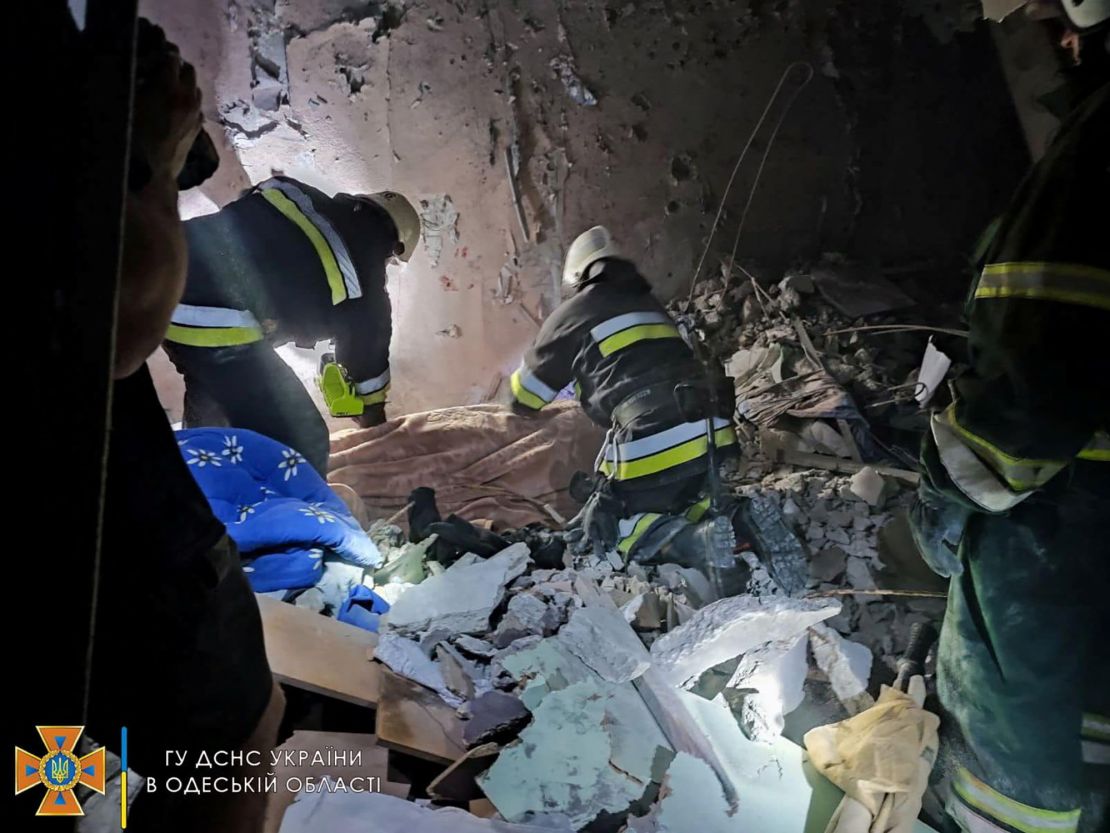 Rescue workers are pictured at the scene of the missile strike.