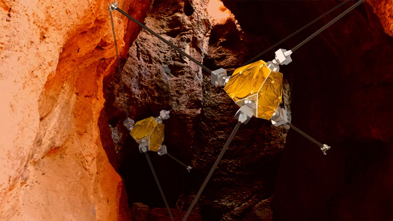 An artist's concept shows ReachBot using its extendable arms to explore a Martian cave.