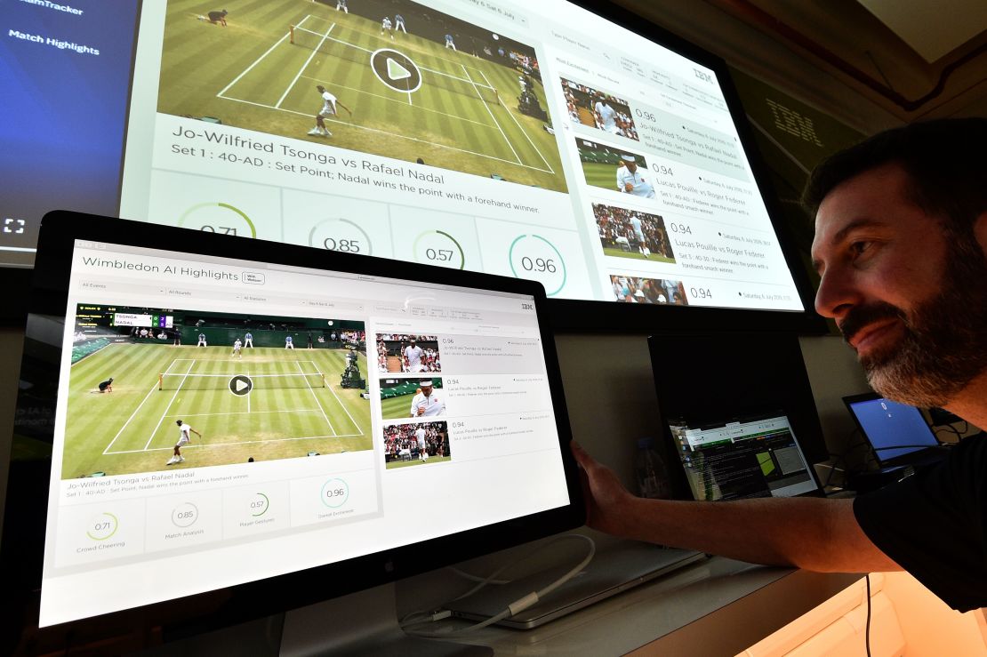 An IBM technician poses with screens showing AI-generated highlights during Wimbledon 2019. The tournament has partnered with IBM to educate the fans at the 2022 tournament.