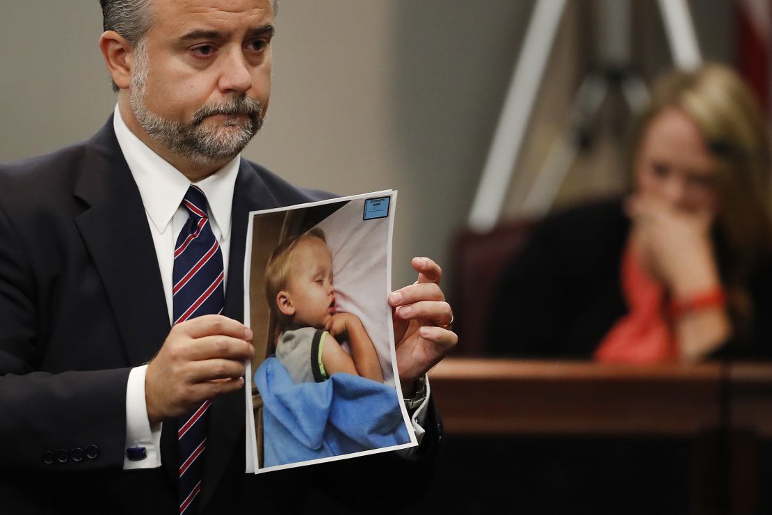Defense attorney Maddox Kilgore holds a photo of Cooper Harris during Justin Ross Harris' murder trial in 2016.