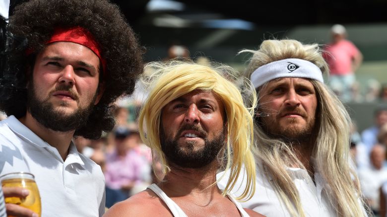 TOPSHOT - Tennis fans wearing wigs resembling legendary players watch Spain's Rafael Nadal play against Luxembourg's Gilles Muller during their men's singles fourth round match on the seventh day of the 2017 Wimbledon Championships at The All England Lawn Tennis Club in Wimbledon, southwest London, on July 10, 2017. / AFP PHOTO / Glyn KIRK / RESTRICTED TO EDITORIAL USE        (Photo credit should read GLYN KIRK/AFP via Getty Images)