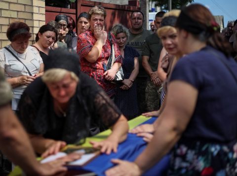 People attend a funeral ceremony for Ukrainian serviceman Volodymyr Kochetov, 46, in the village of Babyntsi, Ukraine, on June 30.