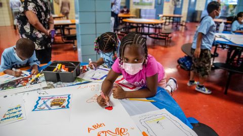 Students write positive affirmations on poster board at P.S. 5 Port Morris, an elementary school in the Bronx borough of New York City, on August 17, 2021. The school system is one of the nation's largest and most segregated.