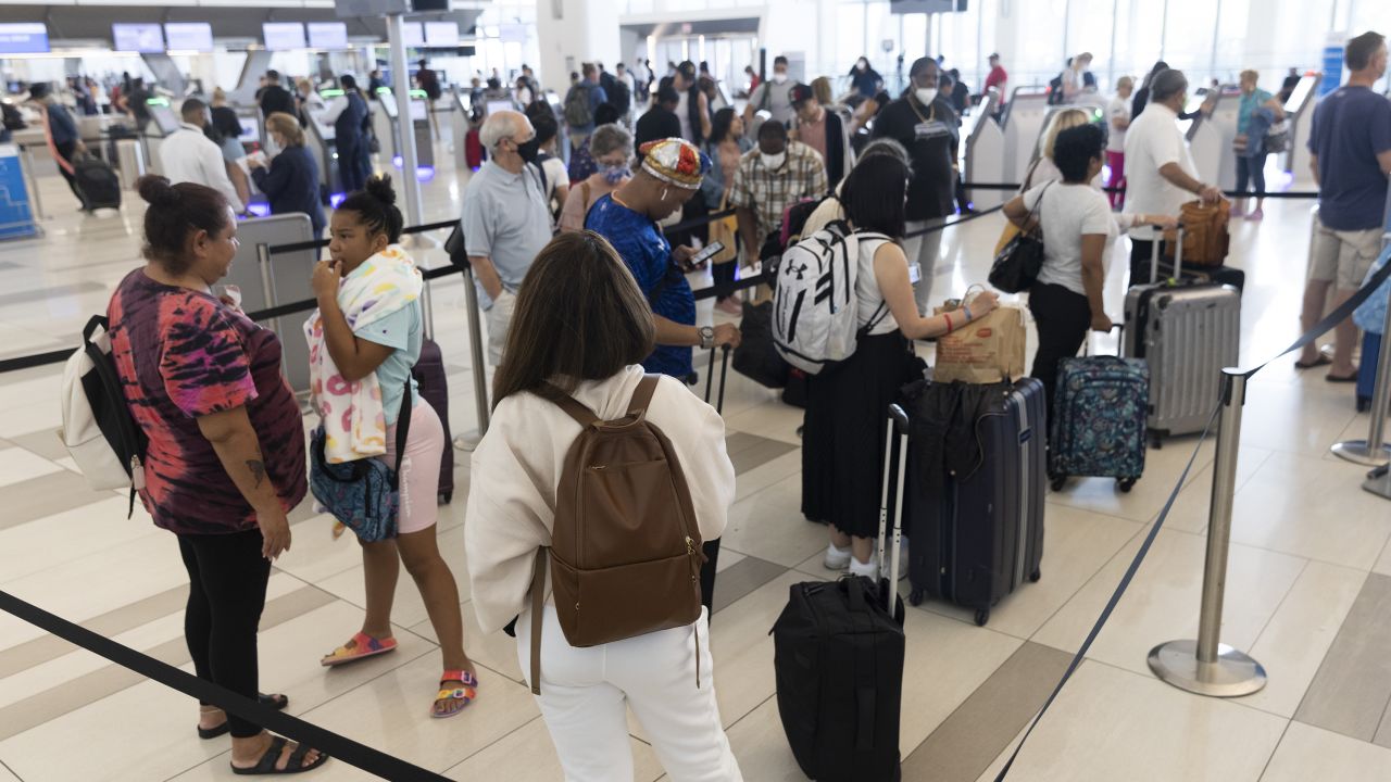 Travelers at LaGuardia Airport (LGA) in the Queens borough of New York, US, on Friday, July 1, 2022. As travel is ramping up for the July 4th holiday, staffing shortages are causing problems for some of the nations largest airlines. 