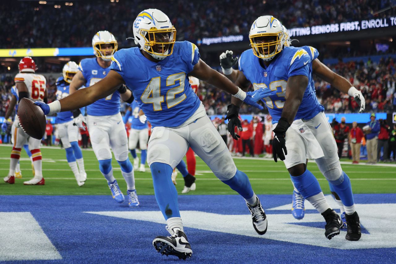 <strong>Uchenna Nwosu</strong> -- Nwosu, of Nigerian descent, celebrates his fourth-quarter interception (left, jersey #42) for the Los Angeles Chargers, during a game against the Kansas City Chiefs in December 2021.