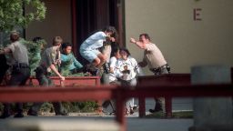 Law enforcement officers assist in the evacuation of students at Lindhurst High School in Olivehurst, Calif. after heavily armed student Eric Houston, took hostages on the campus on May 1, 1992. Houston brushed past teacher Pat Morgan and proceeded to kill civics teacher Robert Brens and three students, and wounded 10 others.

