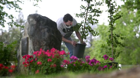 A memorial site at Lindhurst High pays tribute to the victims of the shooting. Here Vincent Furr, a custodian, prepares in 2002 for the 10-year anniversary service. 